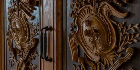 Stunning carved wooden doors entering Le Pavillon's Lafayette Room - wedding venues in Lafayette Louisiana